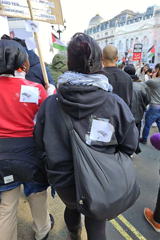 Pro-Palestine protesters wearing Hamas para glider pictures on the streets of London