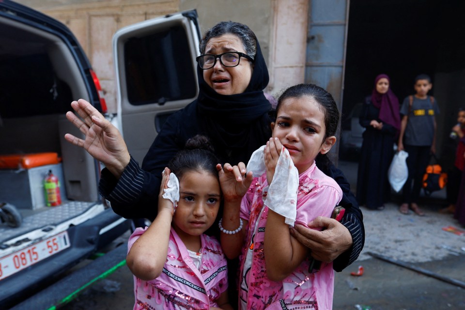 A family cries after being wounded during Israel’s bombardment of Gaza City