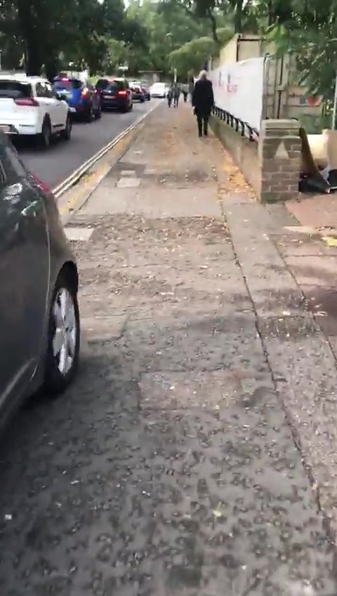 The car appears to drive very near to the person filming