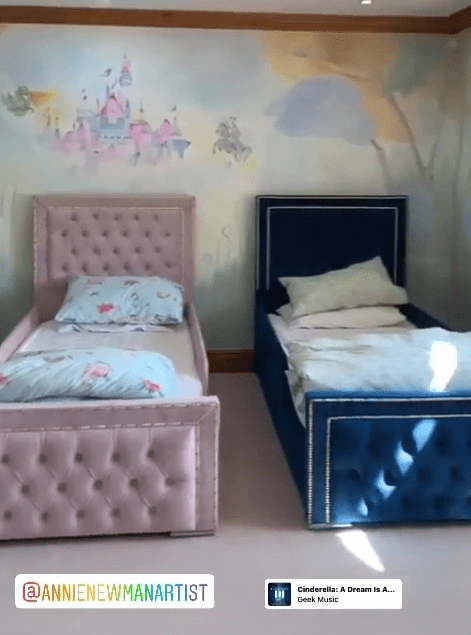 The kids have very plush beds and a castle mural on the wall