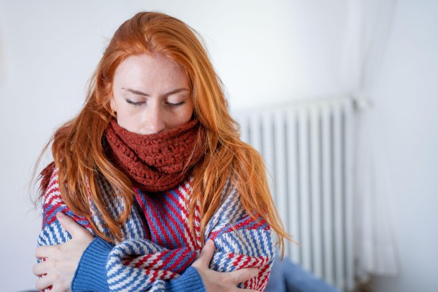 a woman with red hair wearing a scarf around her neck