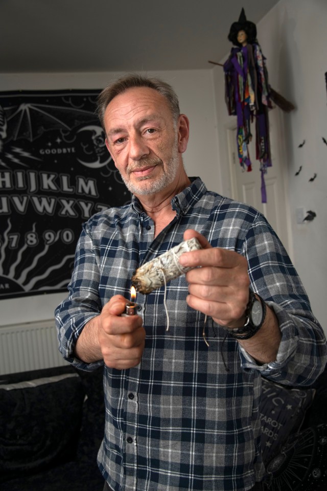 Exorcist Ian Griffiths burning sage to clear negative energy from a home