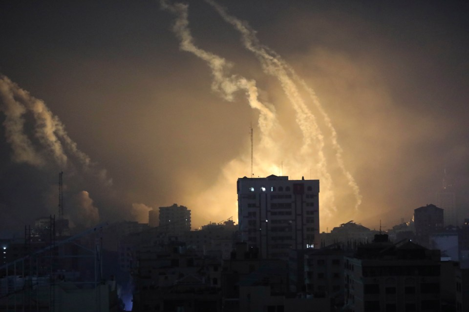 Explosions from the Israeli bombardment are seen on the horizon in northern Gaza