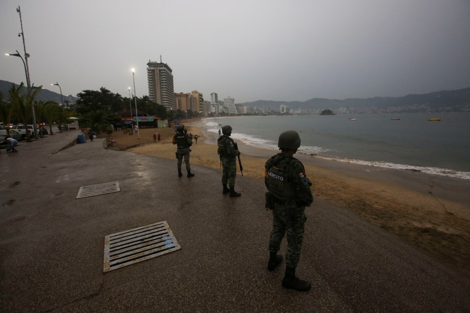 Soldiers keep watch at a beach as the hurricane barrelled towards Acapulco yesterday