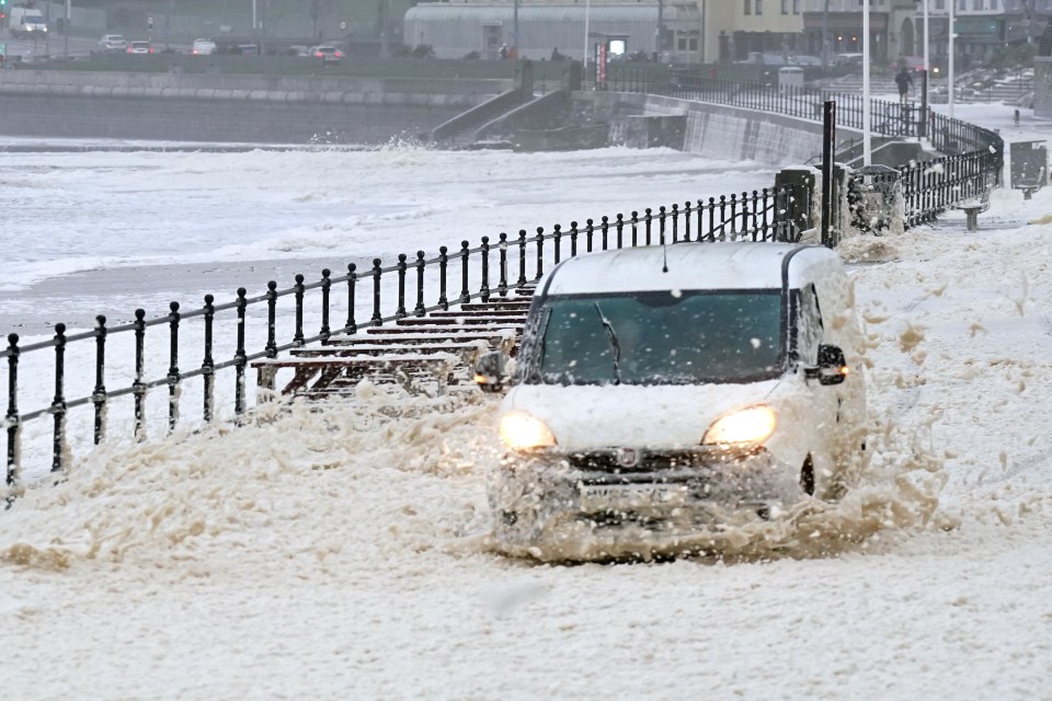 A van battles through sea foam in Seaburn, Sunderland