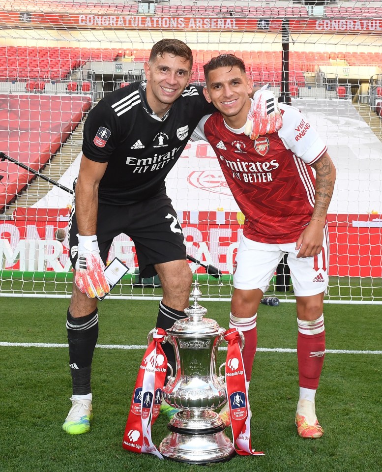 LONDON, ENGLAND - AUGUST 01: Emiliano Martinez (L) and Lucas Torreira of Arsenal celebrate after the FA Cup Final match between Arsenal and Chelsea at Wembley Stadium on August 01, 2020 in London, England. Football Stadiums around Europe remain empty due to the Coronavirus Pandemic as Government social distancing laws prohibit fans inside venues resulting in all fixtures being played behind closed doors. (Photo by Stuart MacFarlane/Arsenal FC via Getty Images)