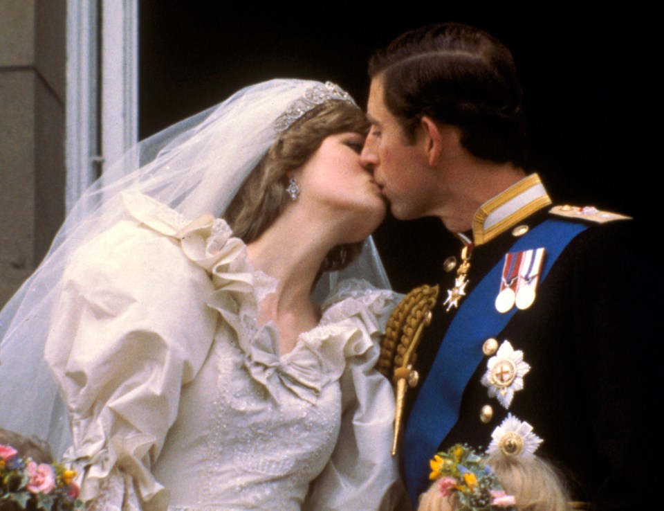 Prince Charles kisses his bride, Princess Diana, on the balcony of Buckingham Palace