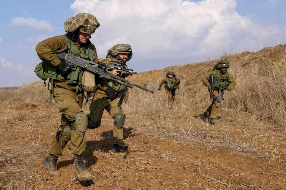 Israeli soldiers take part in drills near its border with Lebanon