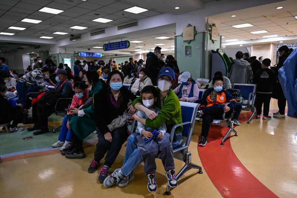 Worried parents wait at the crowded hospital waiting room in Beijing