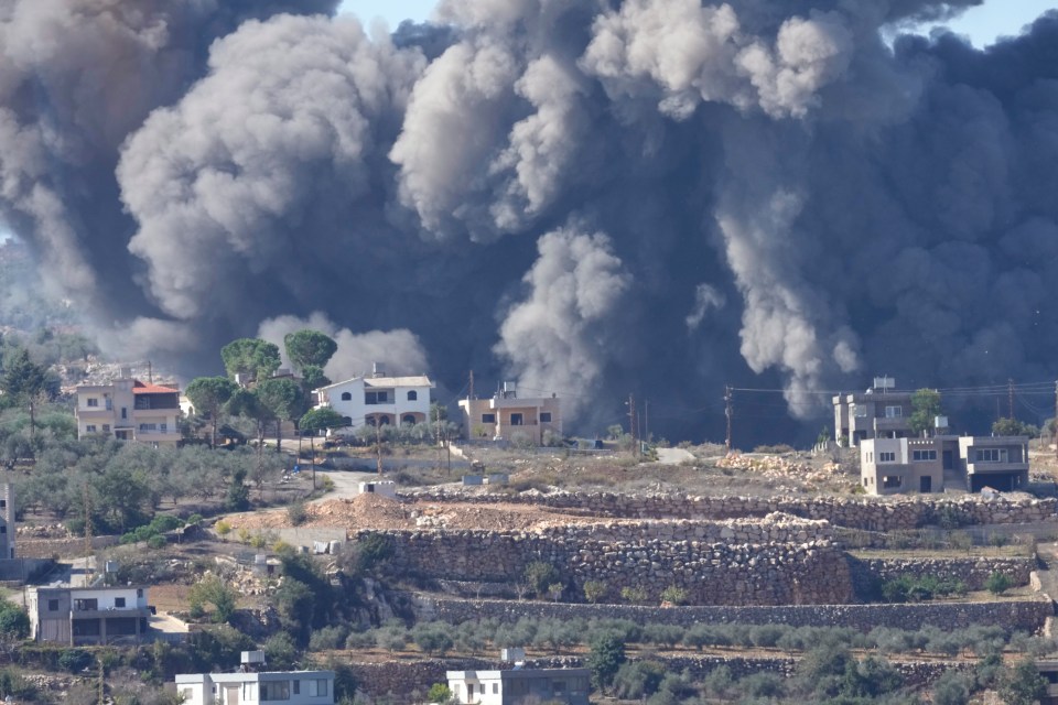 Black smoke rises from an Israeli airstrike on the outskirts of Lebanese border village Aita al-Shaab