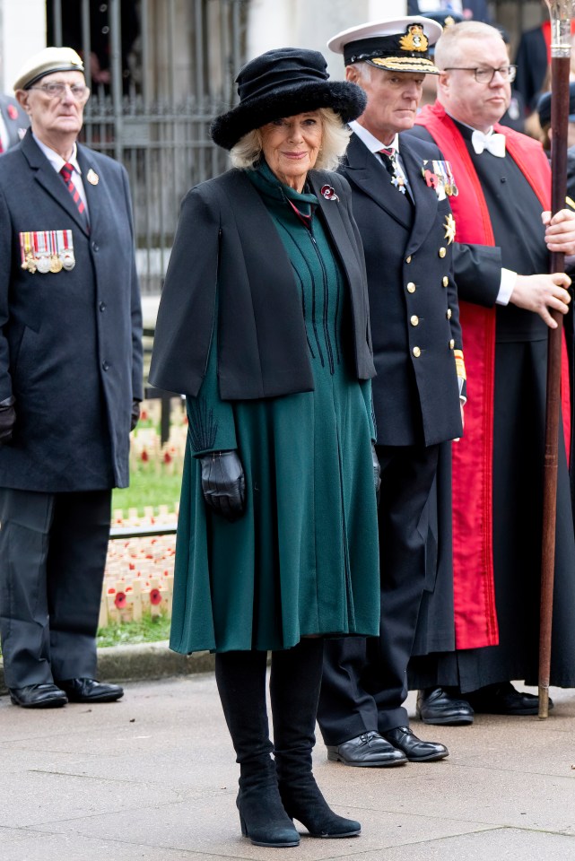 Queen Camilla, in a black cape and hat, laid a tribute to fallen heroes among a sea of crosses at Westminster Abbey yesterday