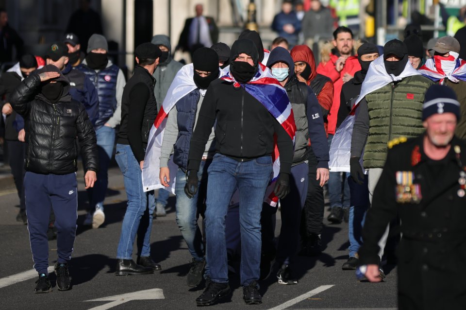 The masked protesters wore the Union Jack and were heard shouting 'England till I die'