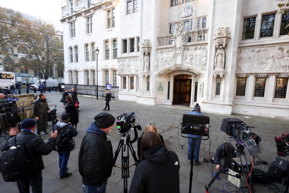 Members of the media stand outside the Supreme Court ahead of its decision on Rwanda deportation flights