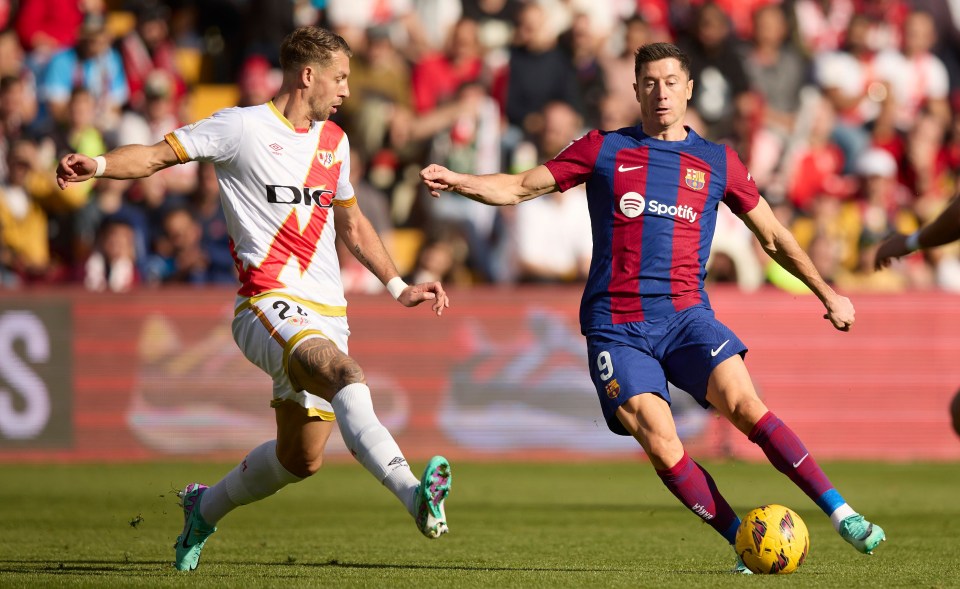 Robert Lewandowski, right, did not get a penalty for the clear foul by Florian Lejeune, left