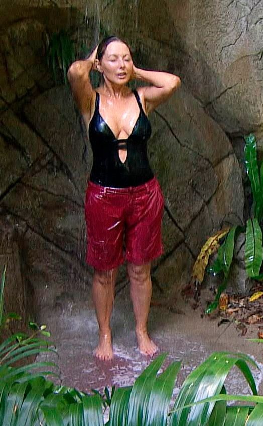 Carol showering in a pair of baggy shorts because she could see three cameras pointed at the shower area