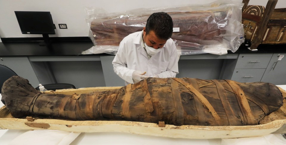 The mummified body of Tutankhamun being restored in Egypt