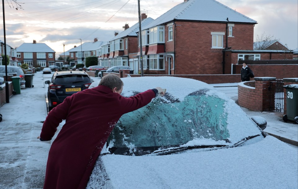 Windscreens covered with ice and snow in Cullercoats, in North Tyneside, this morning