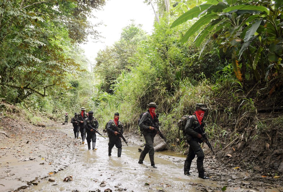 Rebels of the National Liberation Army (ELN) patrol near the Baudo river in Choco province, Colombia on October 26, 2023. (Photo by Daniel Munoz / AFP) (Photo by DANIEL MUNOZ/AFP via Getty Images)