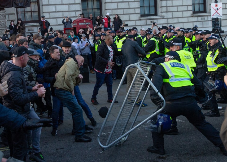 Right-wing protesters draped in Union Jacks attempted to storm the event, breaking down barriers and throwing missiles at the police