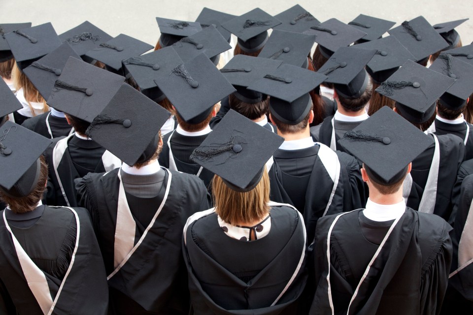 BP3R63 Graduates wait to be photographed after a degree ceremony at Birmingham University in the UK