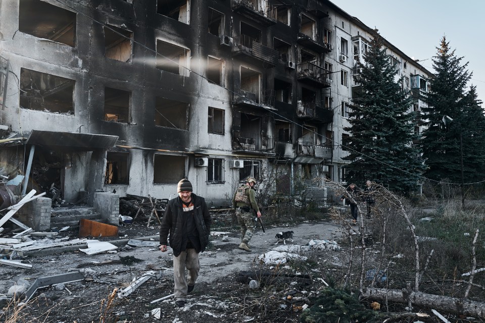 AVDIIVKA, UKRAINE - OCTOBER 30: Police officer Gennady convinces a local resident who lives in a dilapidated house to evacuate on October 30, 2023 in Avdiivka, Ukraine. The National Police of Ukraine, along with the "White Angel" special unit, is conducting an operation to evacuate the remaining local residents from the city, which faces daily destruction from artillery fire. According to the national police, approximately 1,400 people are still in the city. The fighting has escalated in recent days following Russia's major offensive earlier this month. (Vlada Liberova / Libkos via Getty Images)