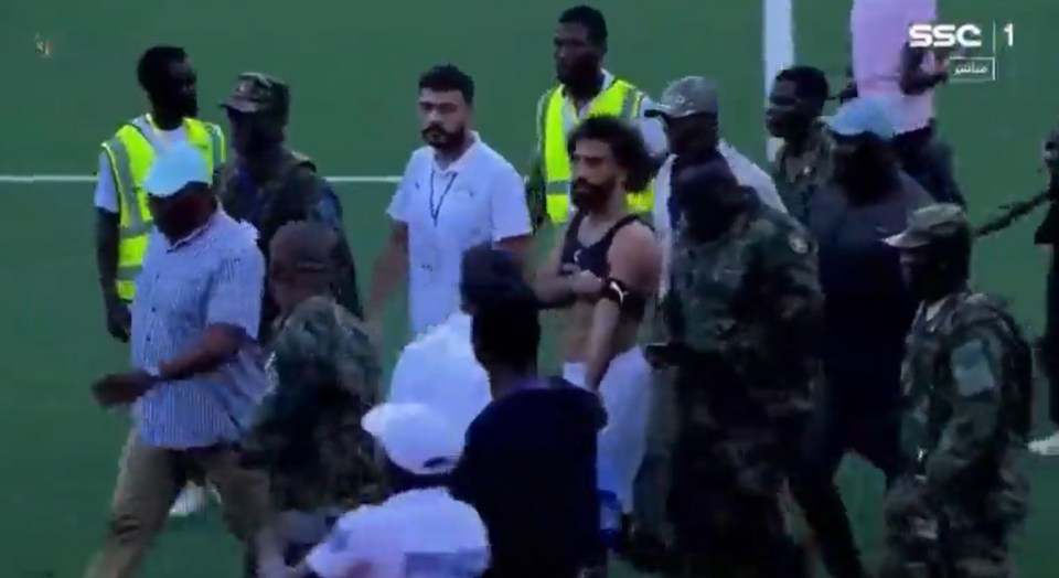 Mo Salah was bundled off the pitch by the army as pitch invaders clashed with security