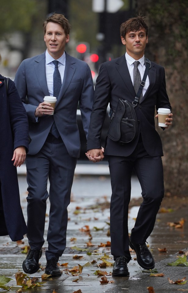 Dustin Lance Black, left, arrives at court today with Tom Daley