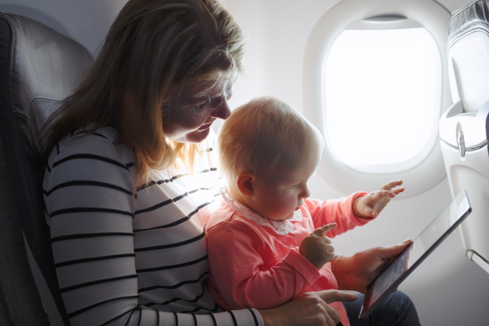 Some carriers charge extra for parents flying with babies on their laps