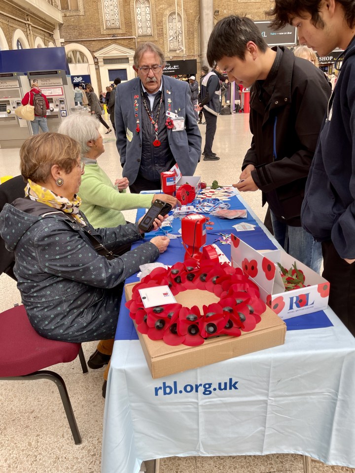 Pictured on Thursday, the same male volunteer has returned to Charing Cross determined to raise money for the Poppy Appeal