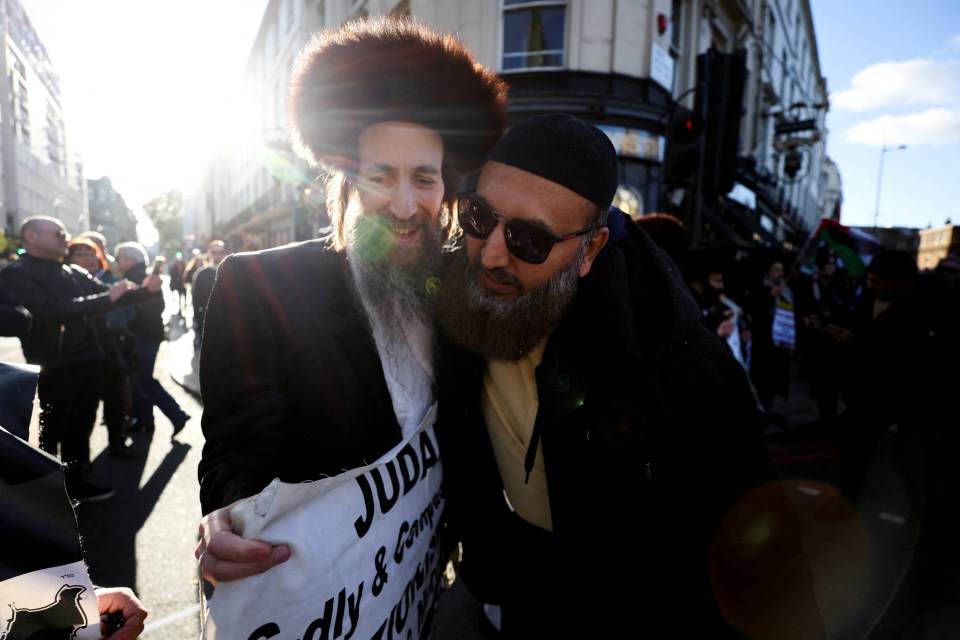 A demonstrator hugs a Jewish man showing support during a protest in solidarity with Palestinians in Gaza