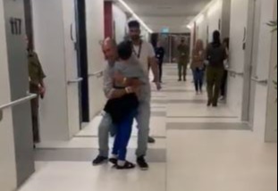 He runs to hug his dad, who picks him up and spins him round in the touching clip