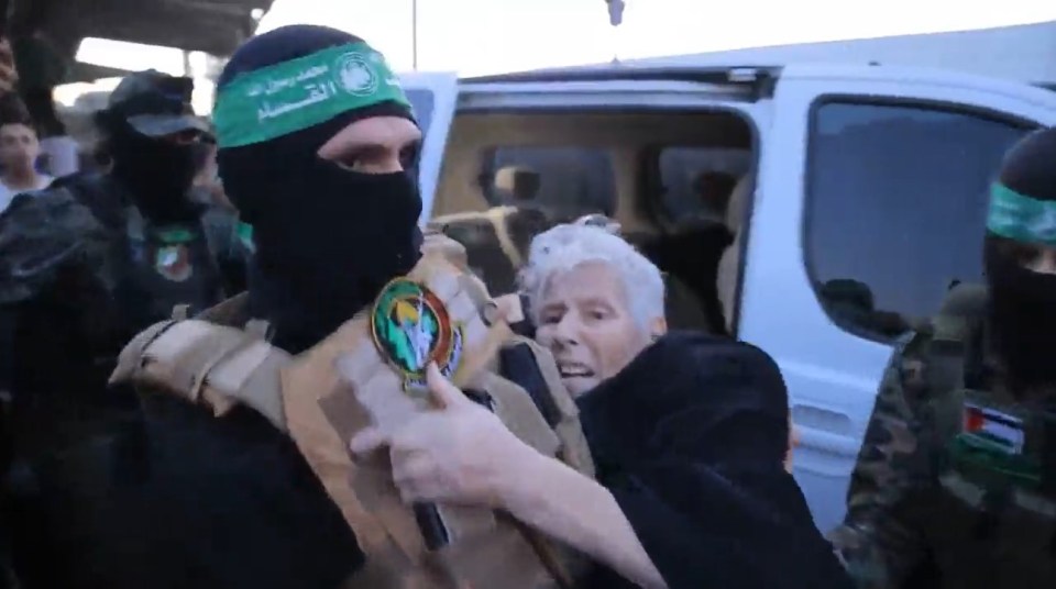 A white-haired woman was seen too weak to walk the short distance between vehicles as a Hamas militant carried her