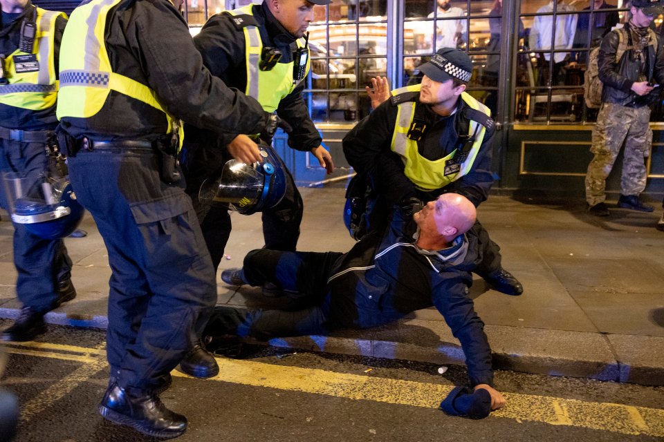 A counter-protester being thrown to the ground by cops as chaos is continuing on the streets of London