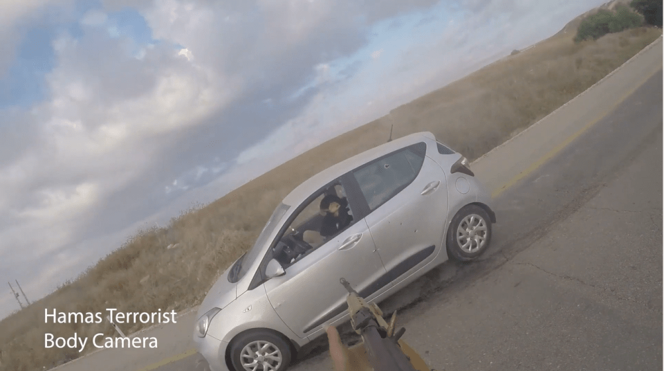 A Hamas terrorist takes aim at two Israeli civilians