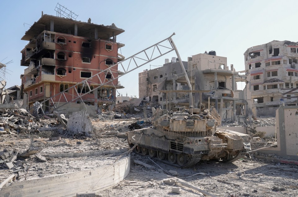 Israeli tank outside shelled flats in Gaza