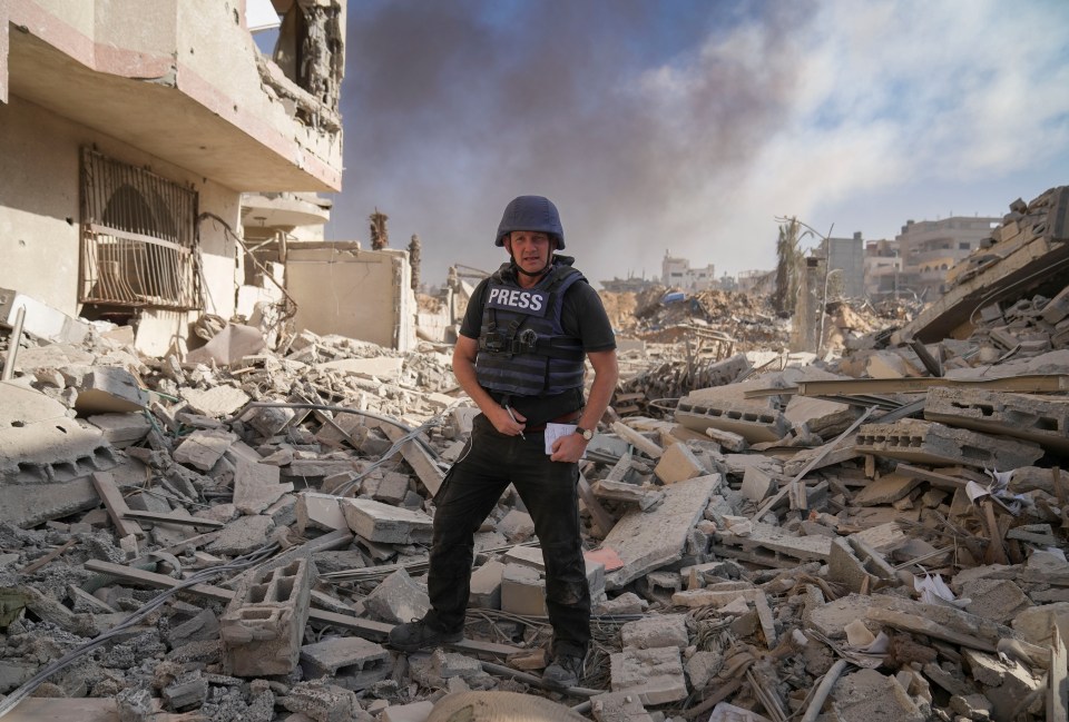 Sun man Paul Sims in the rubble of buildings in Gaza