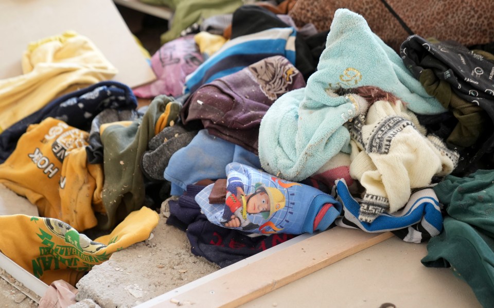 Children’s clothes scattered on the floor including Fireman Sam pyjamas