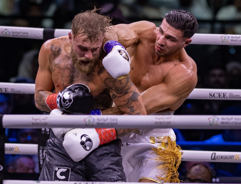 Jake Paul (left) and Tommy Fury boxing.