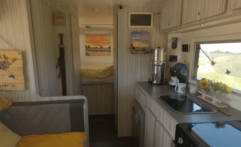 The kitchen area boasts an oven, cooker and grill