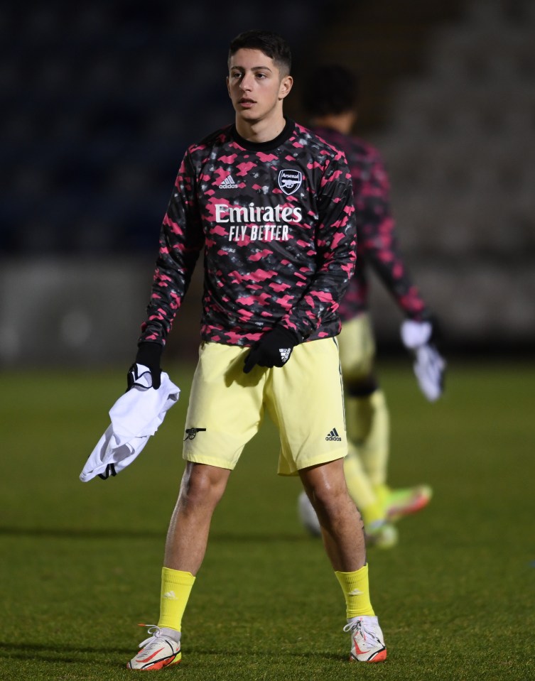 a soccer player wearing a shirt that says emirates fly better