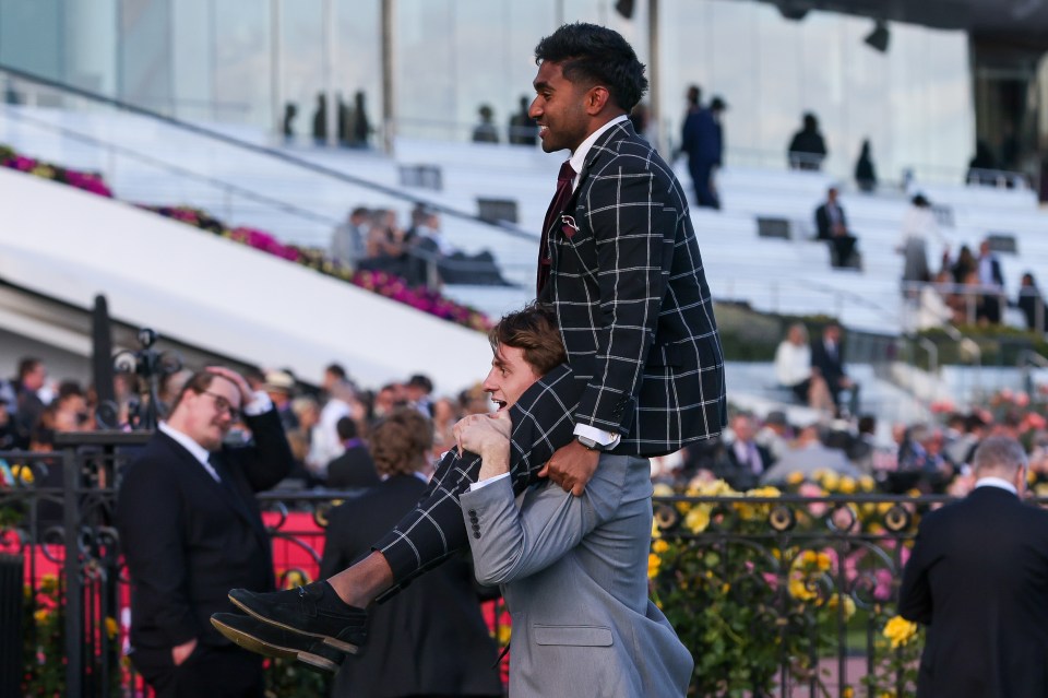 One punter gets a lift from a mate on Victoria Derby day