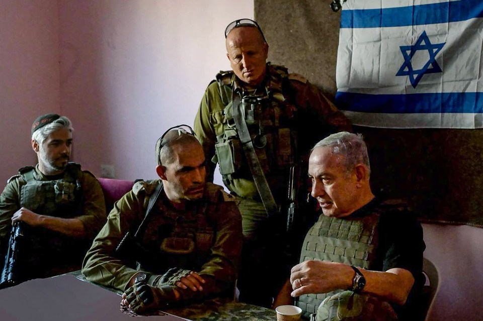 Israeli Prime Minister Benjamin Netanyahu, right, meets soldiers at an undisclosed location in the Gaza Strip on Saturday