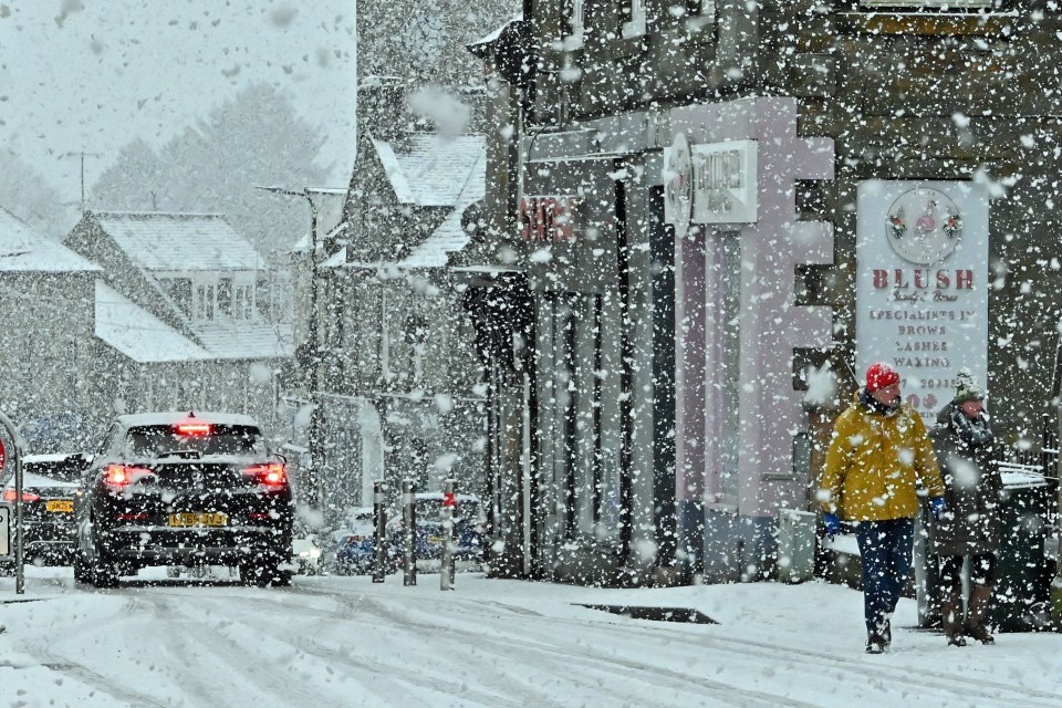 People pictured making their way through falling snow in 2022