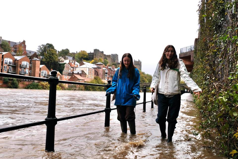 People walk through floodwater in county Durham