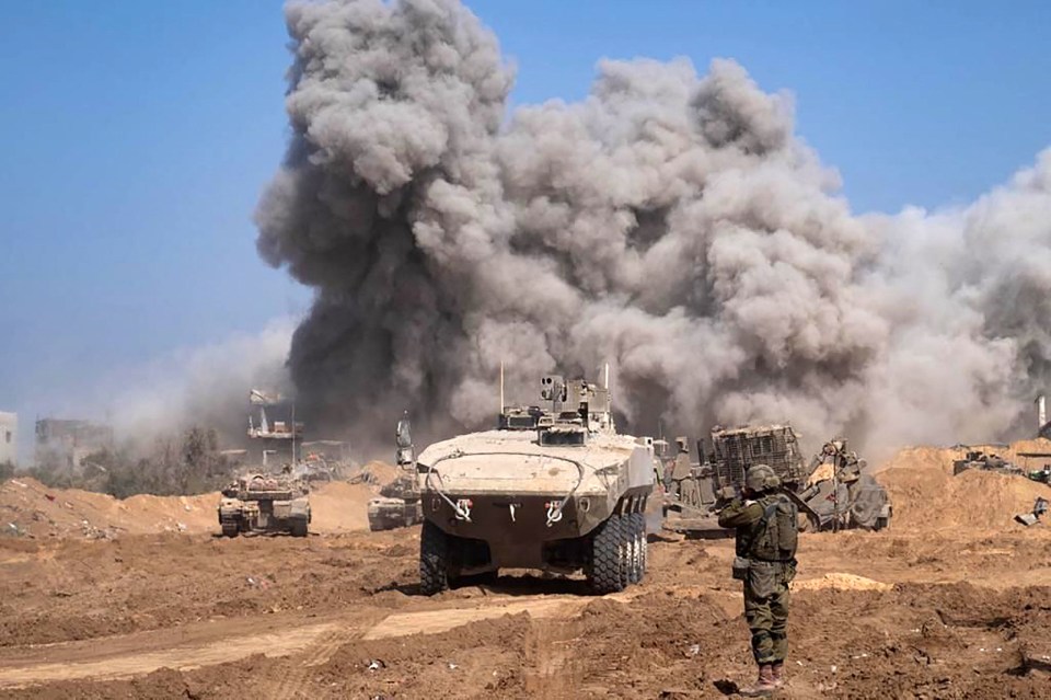 Israel military vehicles and heavy smoke inside the Gaza Strip