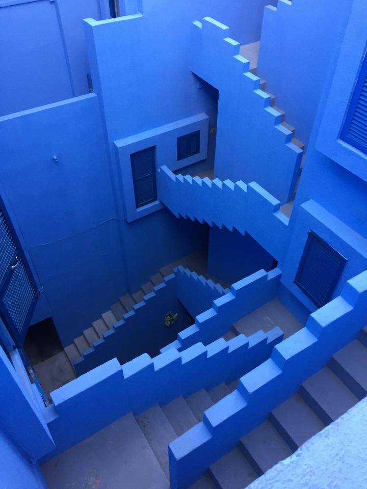 The Spanish complex is made up of blue, red, and pink stairways and bridges