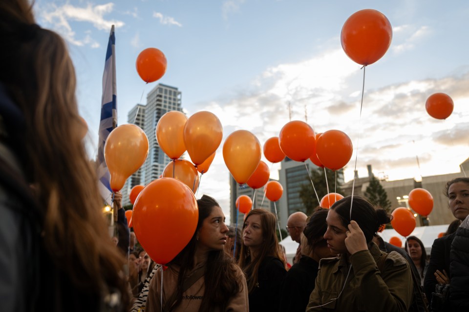 Orange balloons are released at the rally in tribute to Kfir and Ariel's red hair