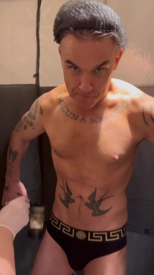 Robbie Williams has stripped to his underpants in a new video