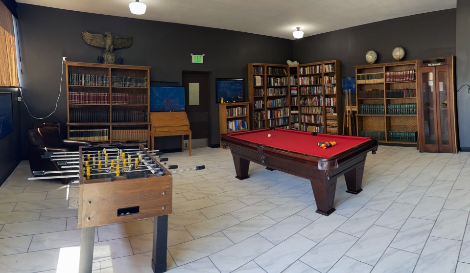 Another room in the converted school with a table football and pool table