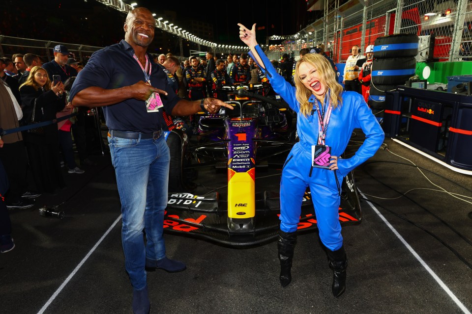 Kylie Minogue posed alongside Verstappen's Red Bull car